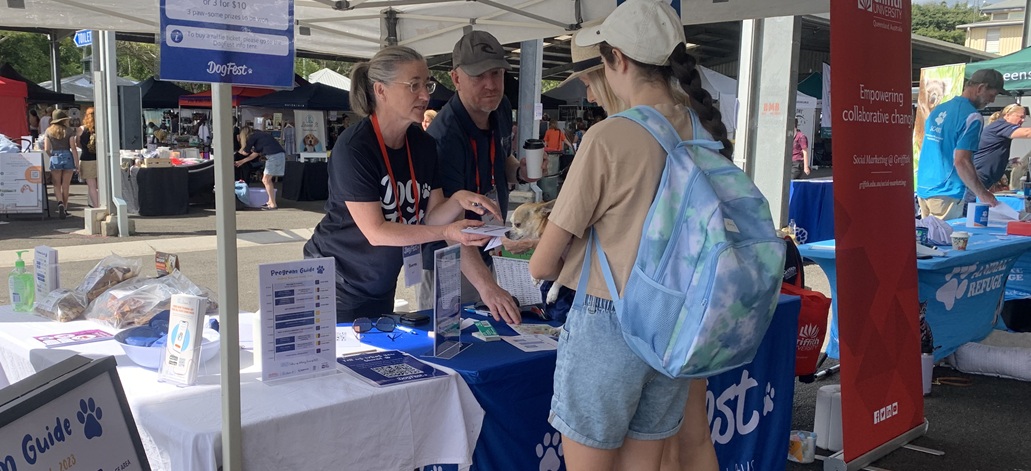 Sharyn at a market stand talking to a member of the public
